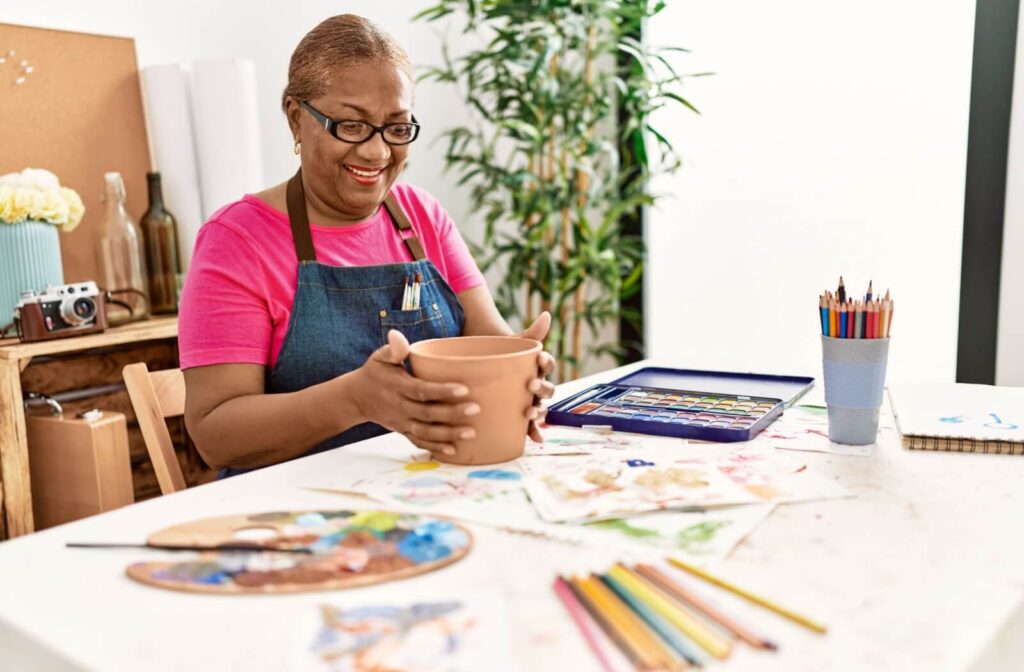 A senior enjoying a crafting kit that was gifted to them.
